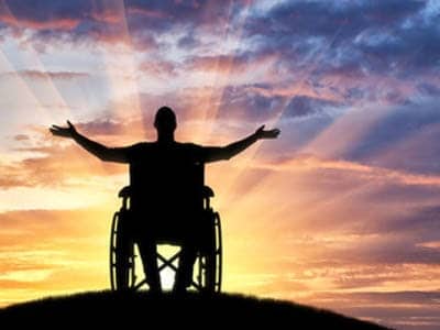 discovery life disability cover man in wheelchair with sunset