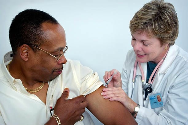 flu vaccine in 2022 man getting flu vaccine from doctor