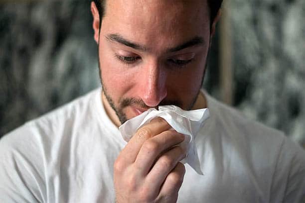 flu vaccine in 2022 man with runny nose