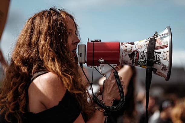 womans month august 2022 woman with loud hailer fighting for womans rights