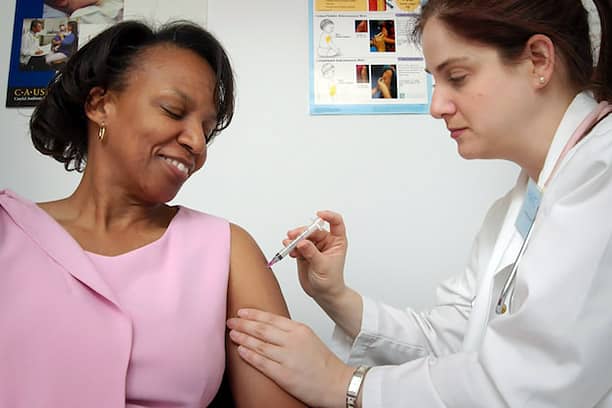 informed healthcare solutions flu vaccination in 2023 april newsletter woman getting flu shot