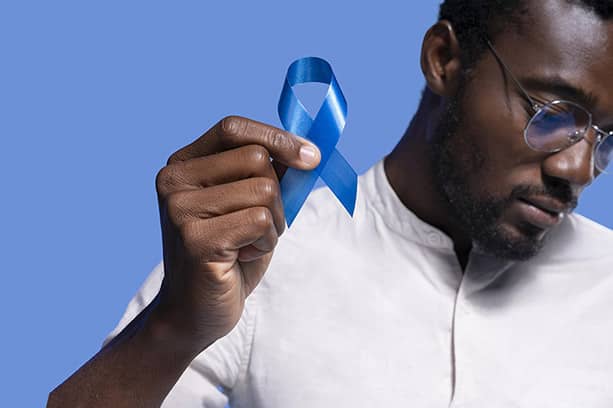 informed healthcare solutions world cancer day 2024 man holding up blue cancer ribbon