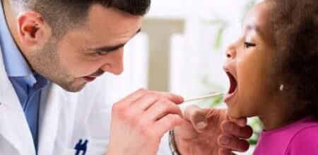 discovery hospital plan with savings doctor checking little girls throat